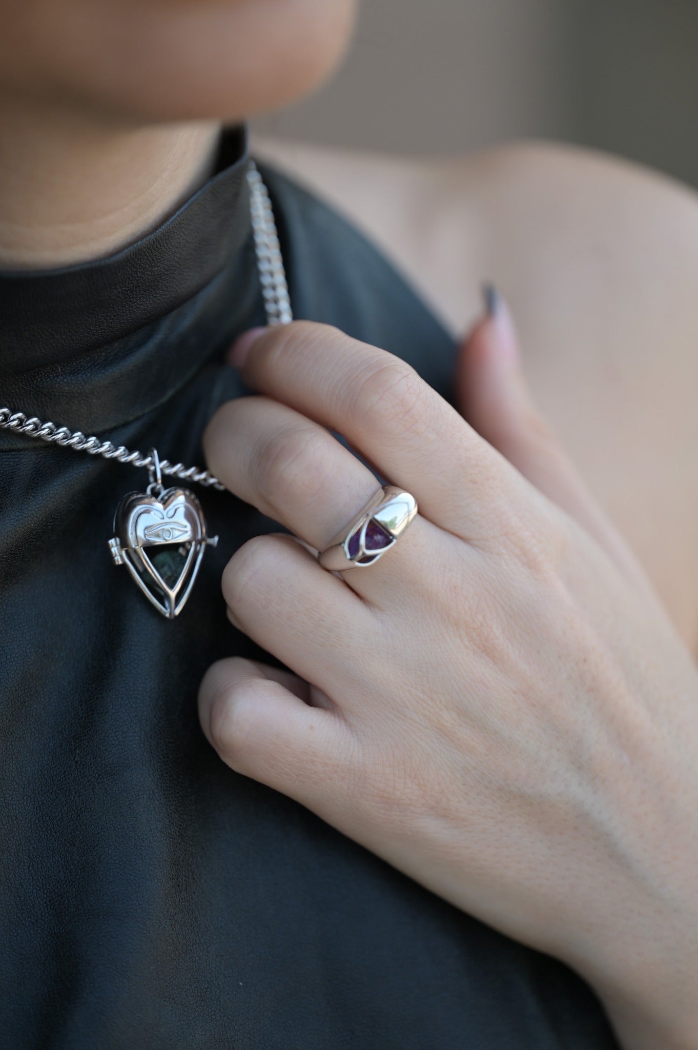 Silver Lovers Heart pendant worn against black leather